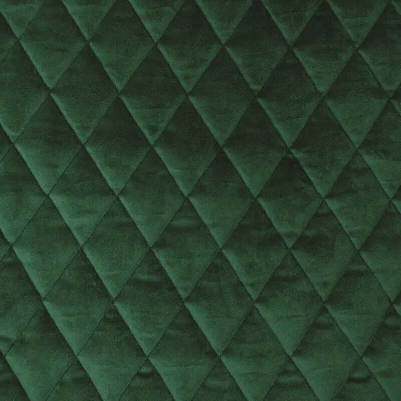 Emeraldgrön quiltad sammetstextur för en lyxig fåtölj, med diamantmönster.