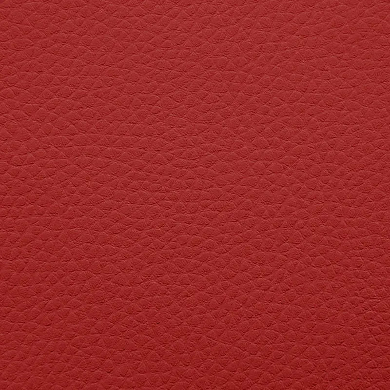 Närbild på mörkröd, texturerad sittsäck fåtölj i konstläder, perfekt för lounge.
