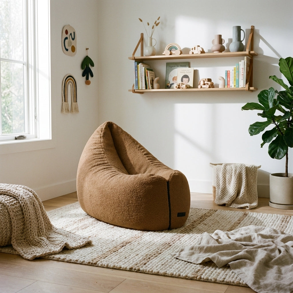 Cozy, modern nursery featuring a tan boucle beanbag chair, wooden wall shelves, neutral decor, and a soft area rug.